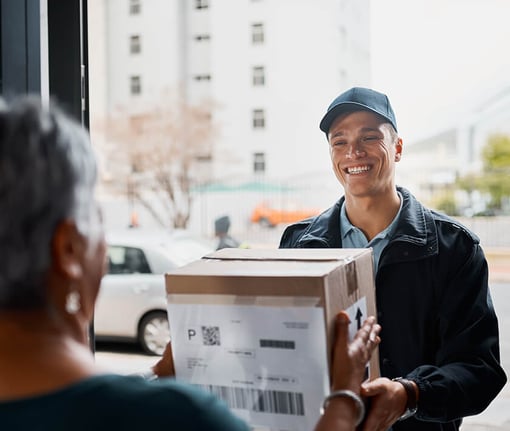 delivery man dropping off a package to a woman